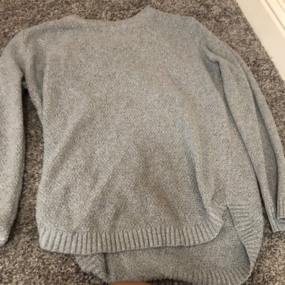 This is a gray knitted sweater very comfortable for cold nights